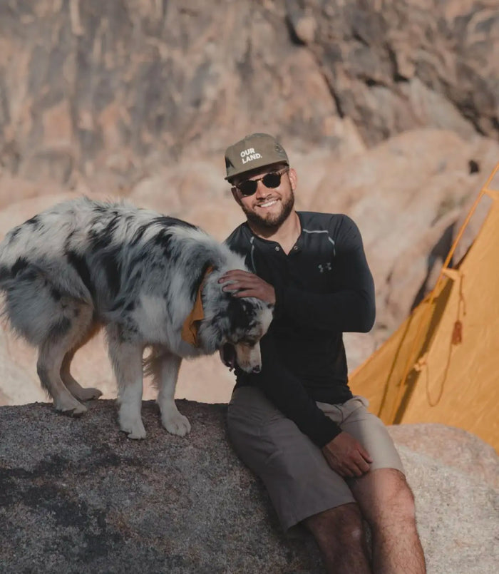 Karim Bouhdary in the outdoors with a dog.