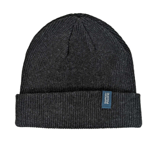 Dark gray knit beanie with a blue label on a light gray background