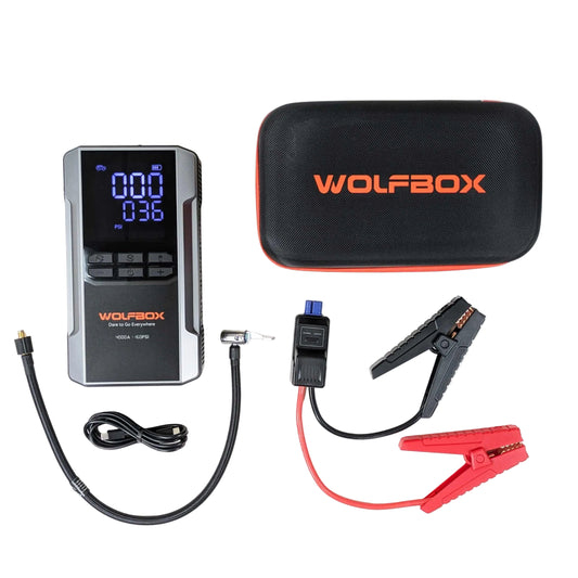 Wolfbox jump starter with digital display and cables on a white background