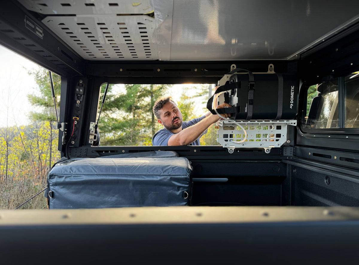 Interior storage and accessory mounting in Rivian R1T X1 camper