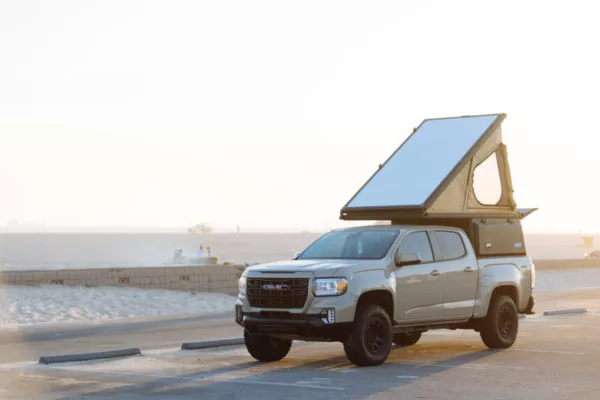 GMC Canyon parked near the beach with Super Pacific X1 Camper mounted to the truckbed.