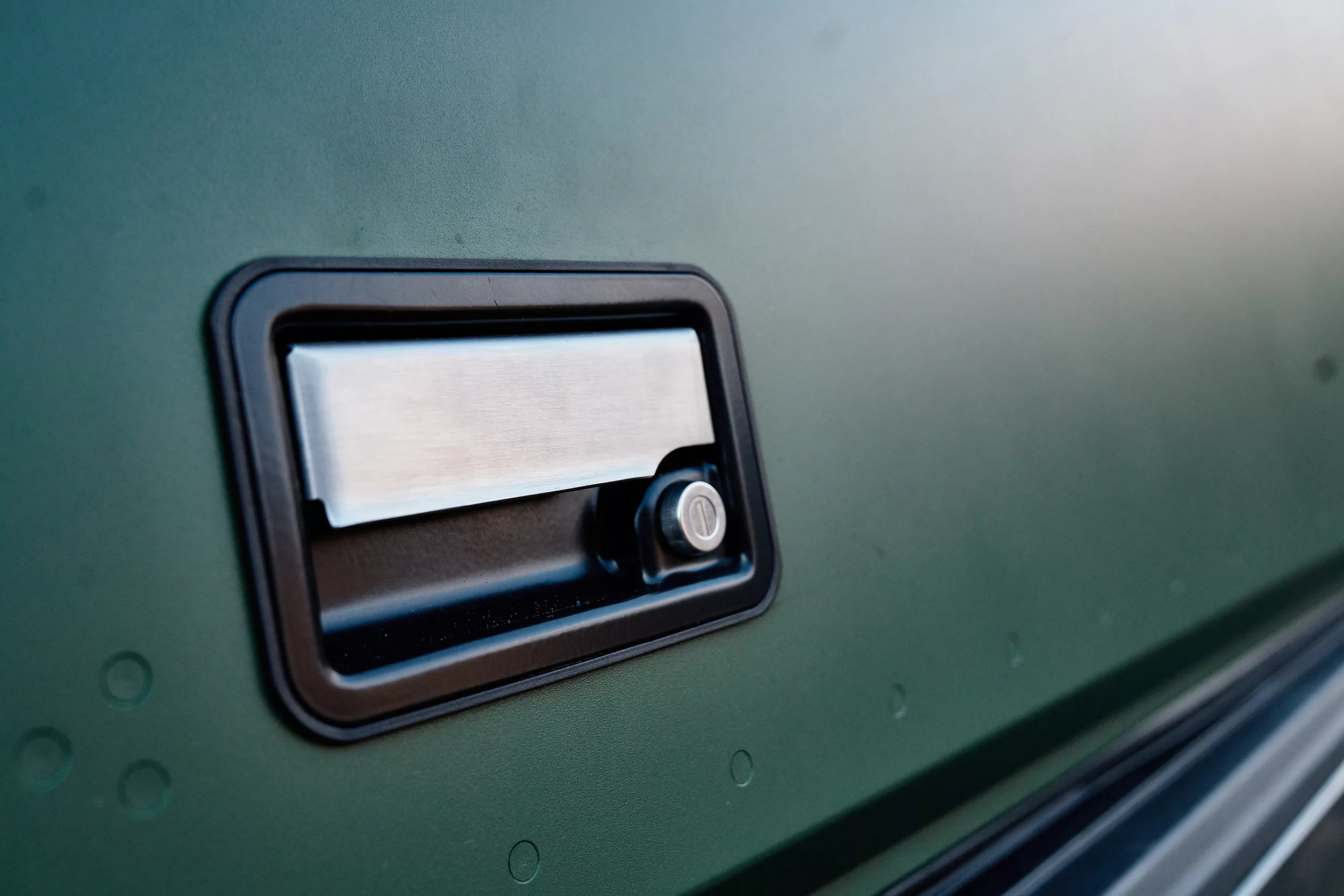 Close-up of side door handle of Super Pacific X1 Camper.
