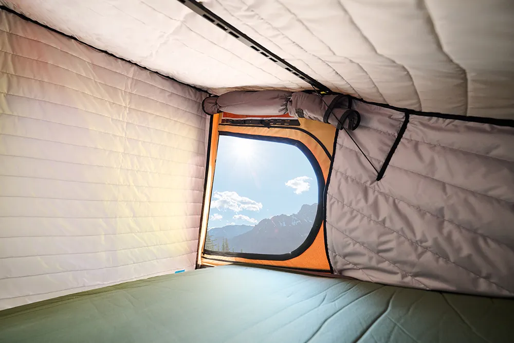 X1 Camper with Insulation Kit installed looking out at a mountain top.