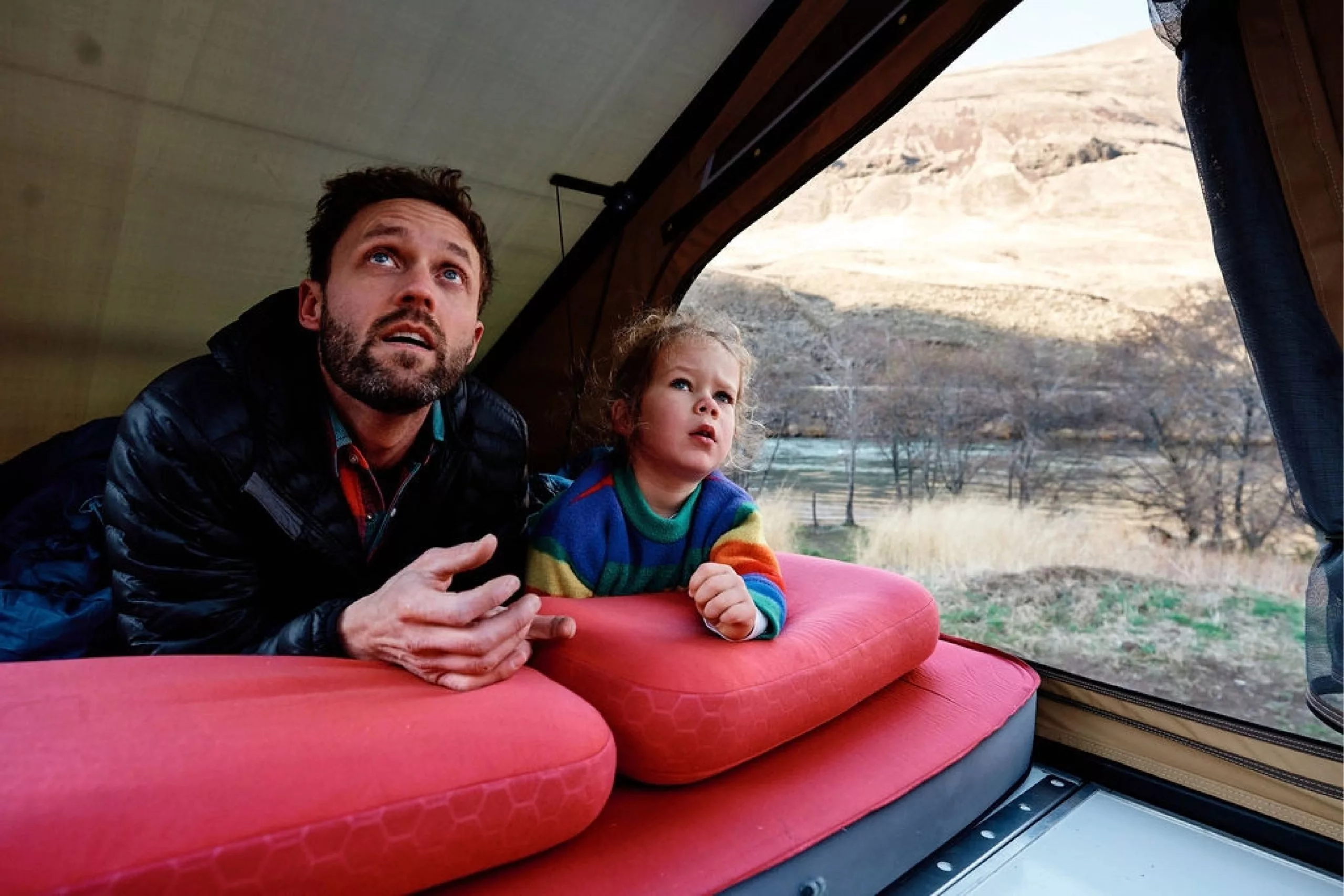 Man and his son gazing into the distance from the bed of their X1 Tacoma Truckbed camper.