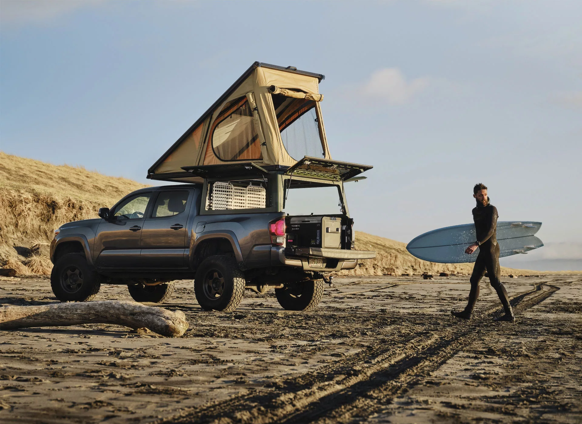Toyota Tacoma with X1 truck camper on a beach in the Pacific Northwest.